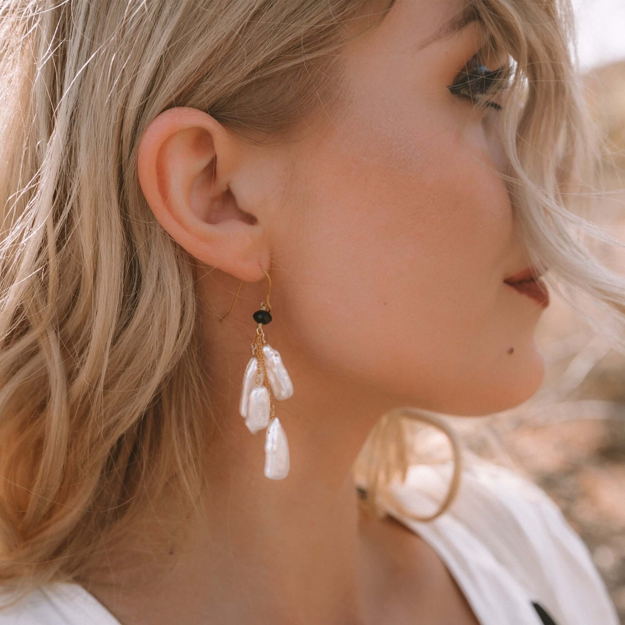 White Pearl Dangle in a Gold Earrings 