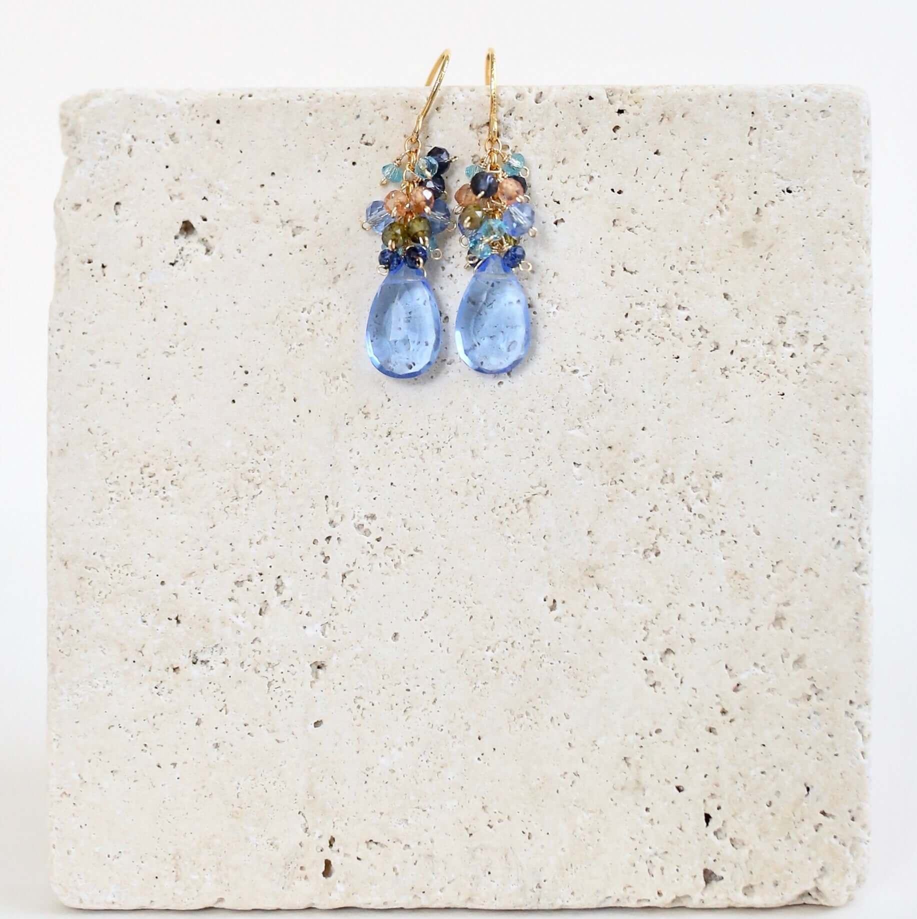 Gold drop earrings made with sky blue quartz topped with a blue cluster of gems