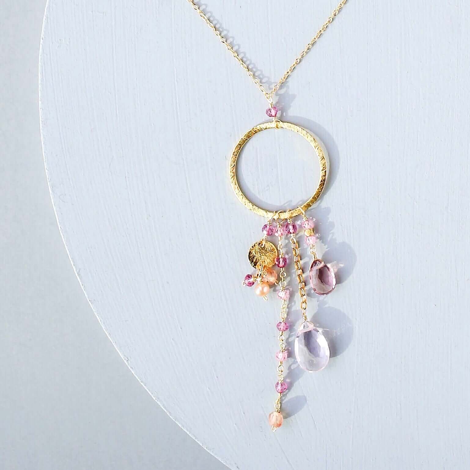 Multiple strands of lush gems sparkle on a hoop with rose quartz and pink tourmaline  gemstone Pendant Gold Necklace