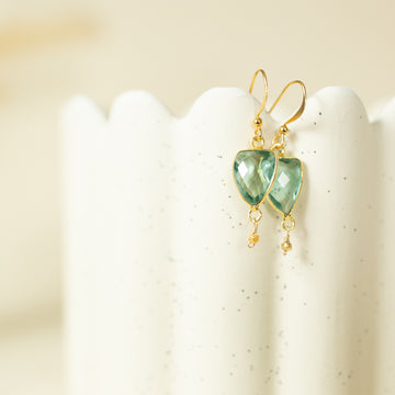 Green amethyst inverted triangle shaped earrings on a white background
