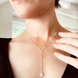 A girl radiates timeless elegance wearing The Kensington Collection's delicate pearl necklace.