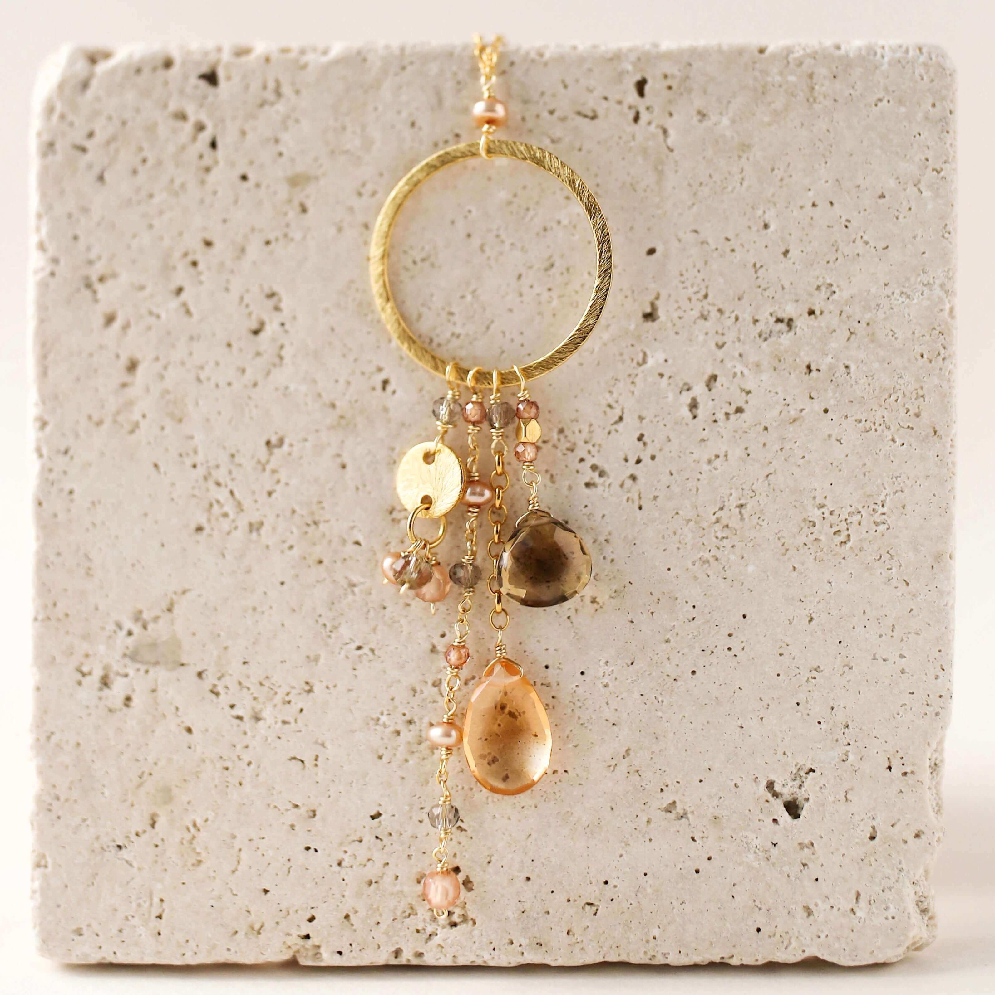 Multiple strands of lush gems sparkle on a hoop with citrine and smoky quartzt Gemstone Pendant Gold Necklace