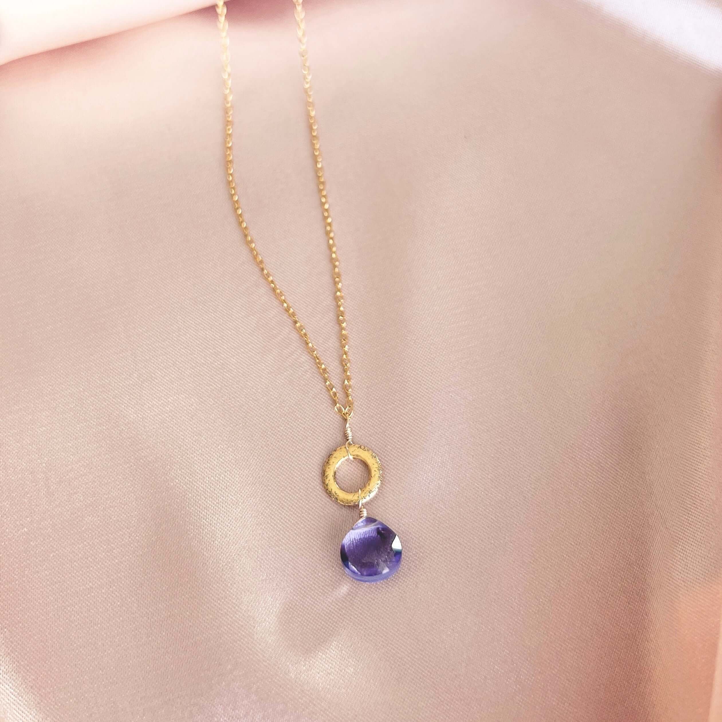 Layering chain with timeless amethyst gemstone. 14k gold plated .925 Italian silver, 16" length (extendable to 18"). Each stone unique, laid on a satin pink cloth.