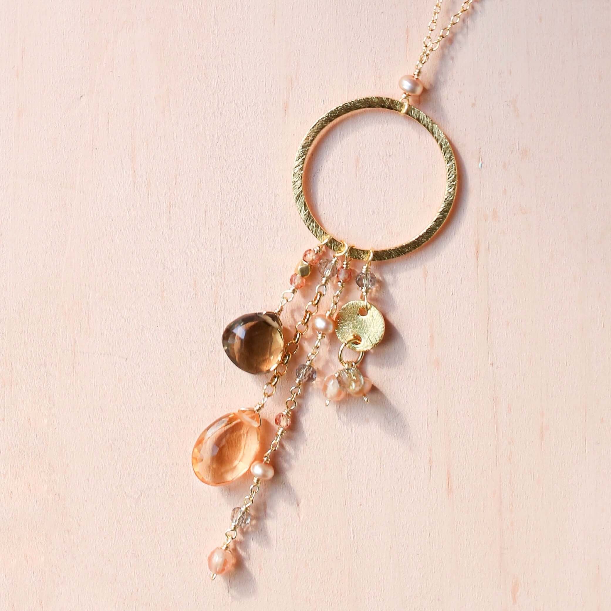 Multiple strands of lush gems sparkle on a hoop with citrine and smoky quartzt Gemstone Pendant Gold Necklace