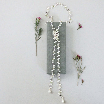 Lariat necklace with 45 inches of freshwater bead pearls and multi-colored gemstones, including garnet, peridot, amethyst, and champagne quartz