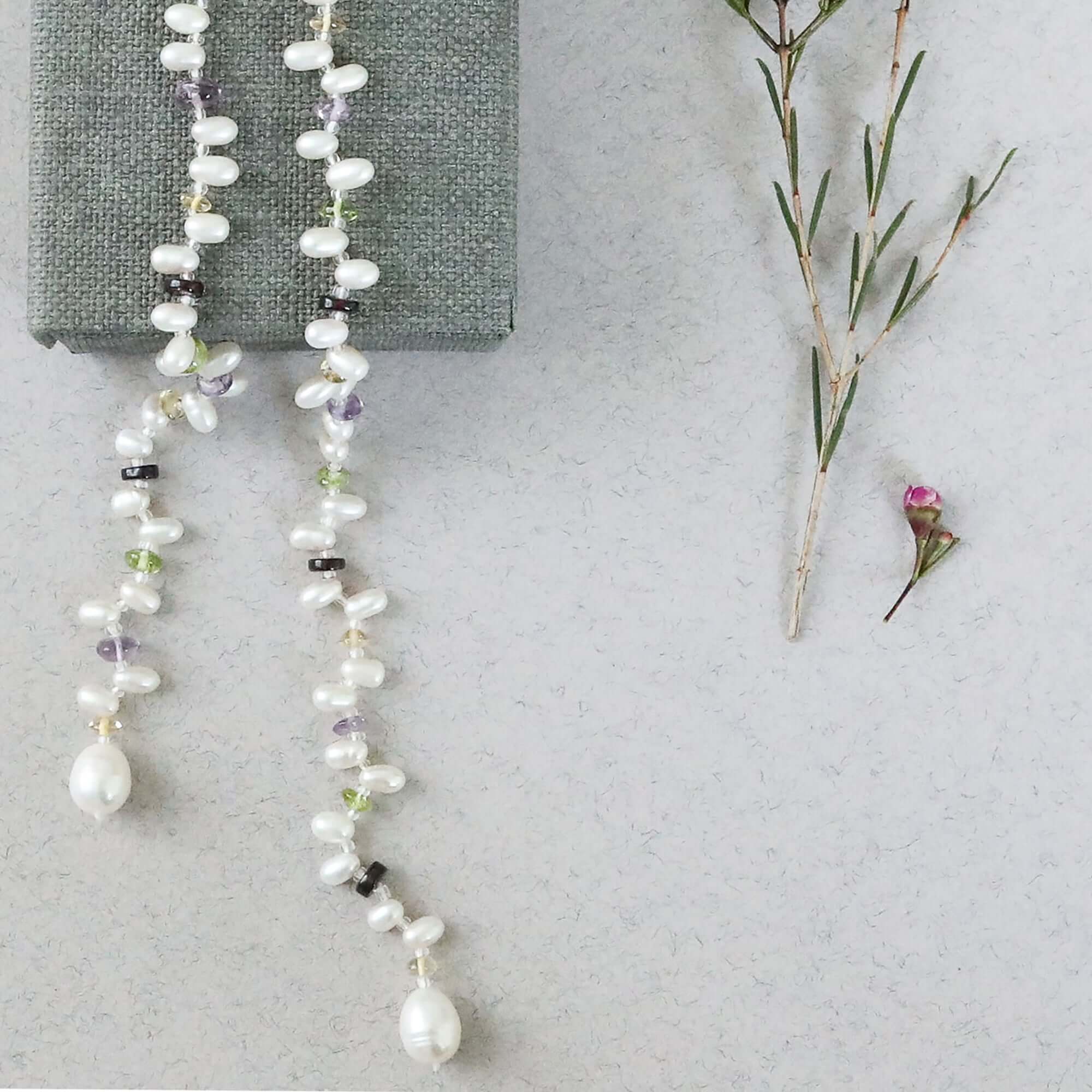 Lariat necklace with 45 inches of freshwater bead pearls and multi-colored gemstones, including garnet, peridot, amethyst, and champagne quartz