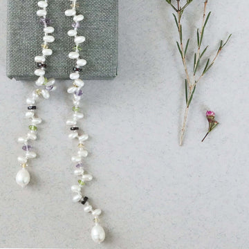 Lariat necklace with 45 inches of freshwater bead pearls and multi-colored gemstones, including garnet, peridot, amethyst, and champagne quartz