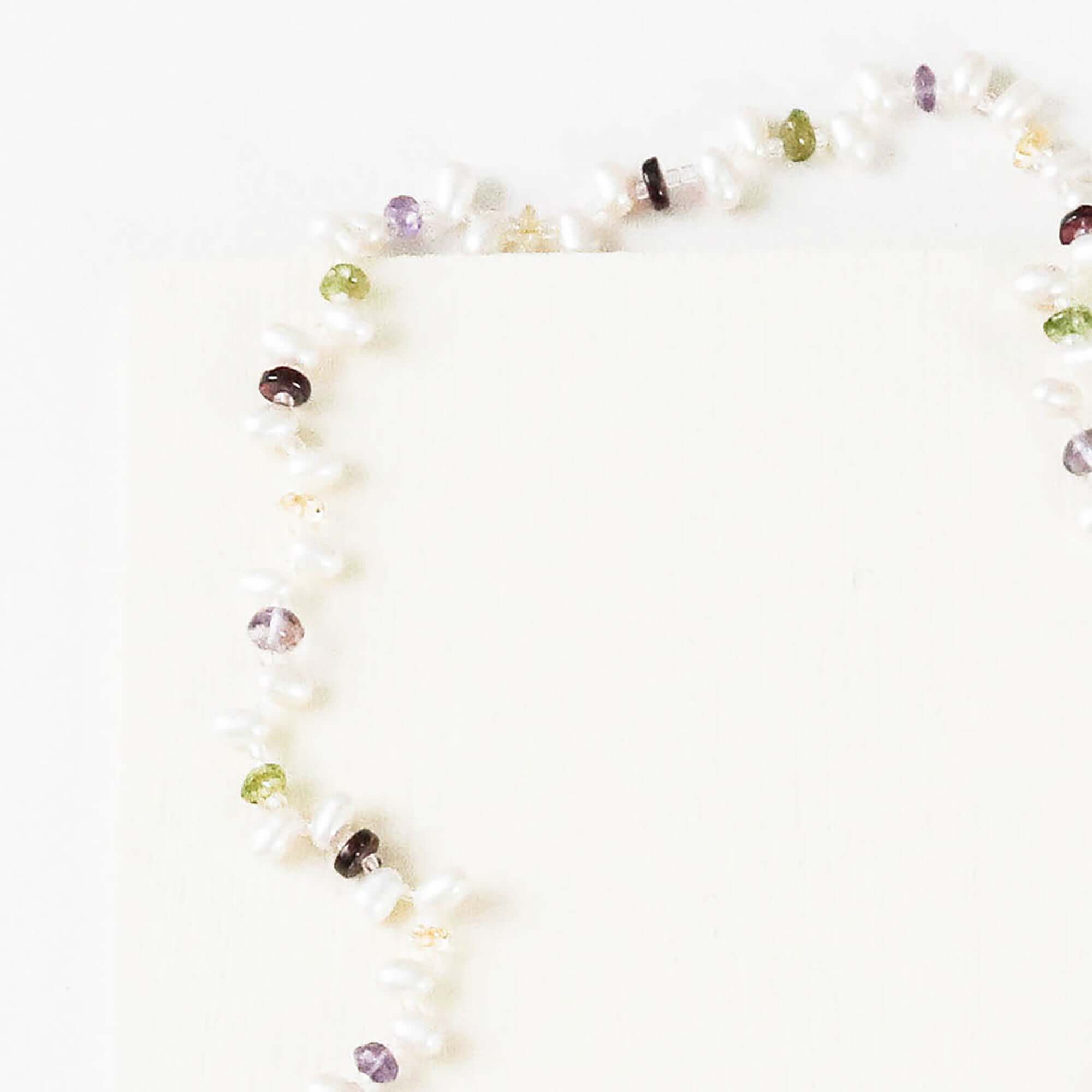 Lariat necklace with 45 inches of freshwater bead pearls and multi-colored gemstones, including garnet, peridot, amethyst, and champagne quartz