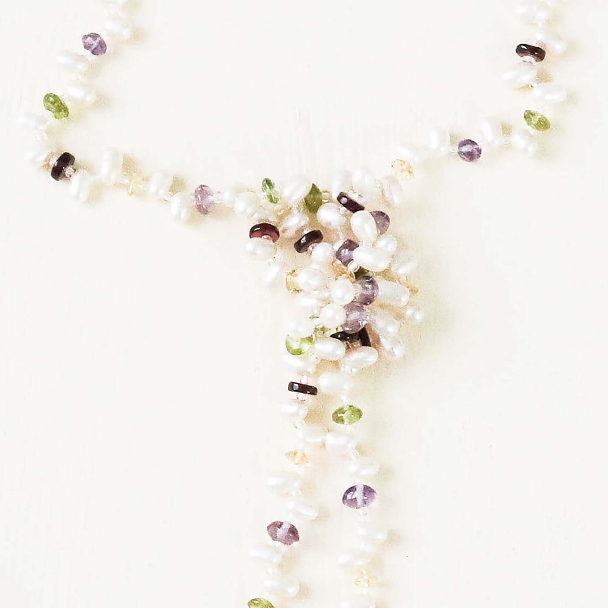 Lariat necklace with 45 inches of freshwater bead pearls and multi-colored gemstones, including garnet, peridot, amethyst, and champagne quartz