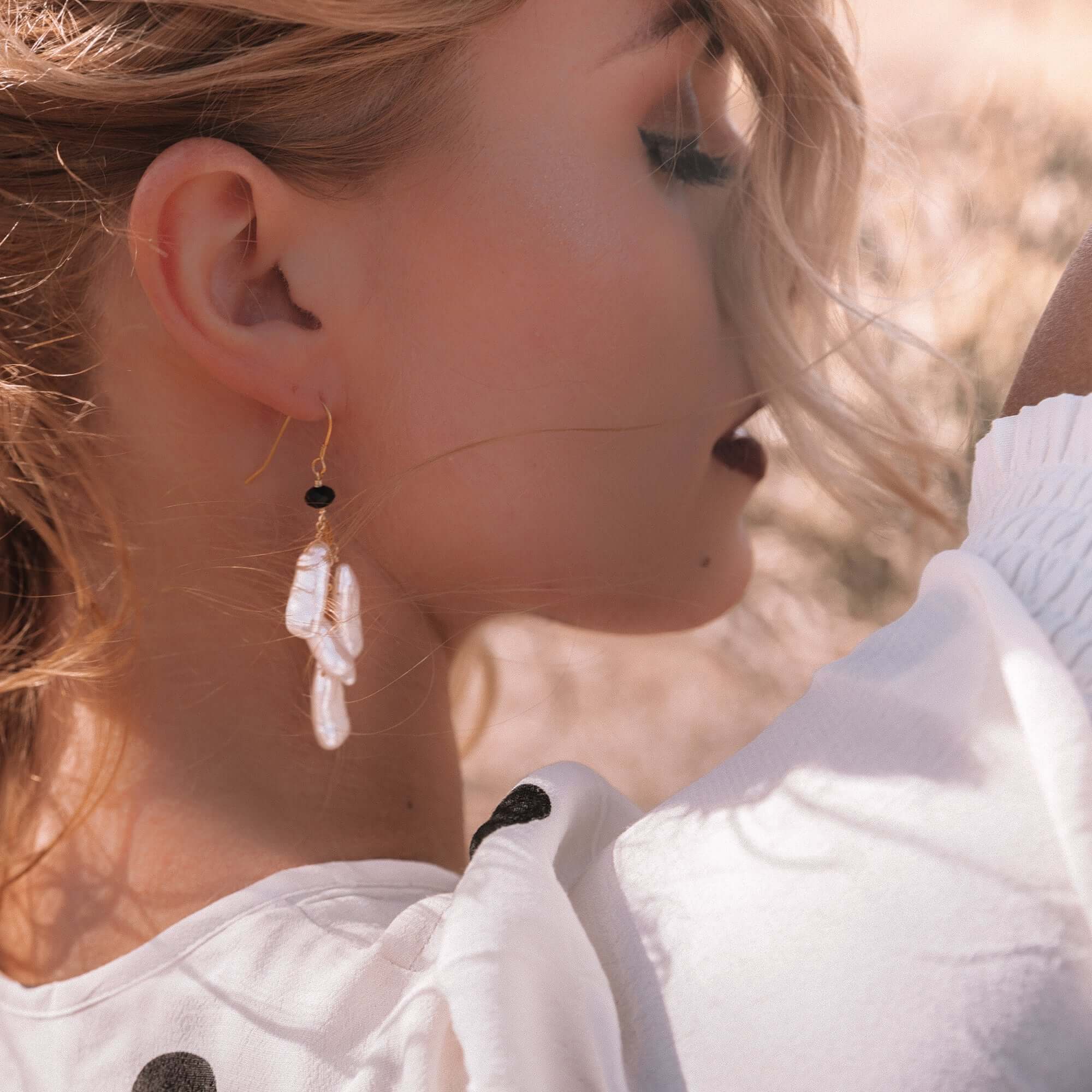 White Pearl Dangle in a Gold Earrings 