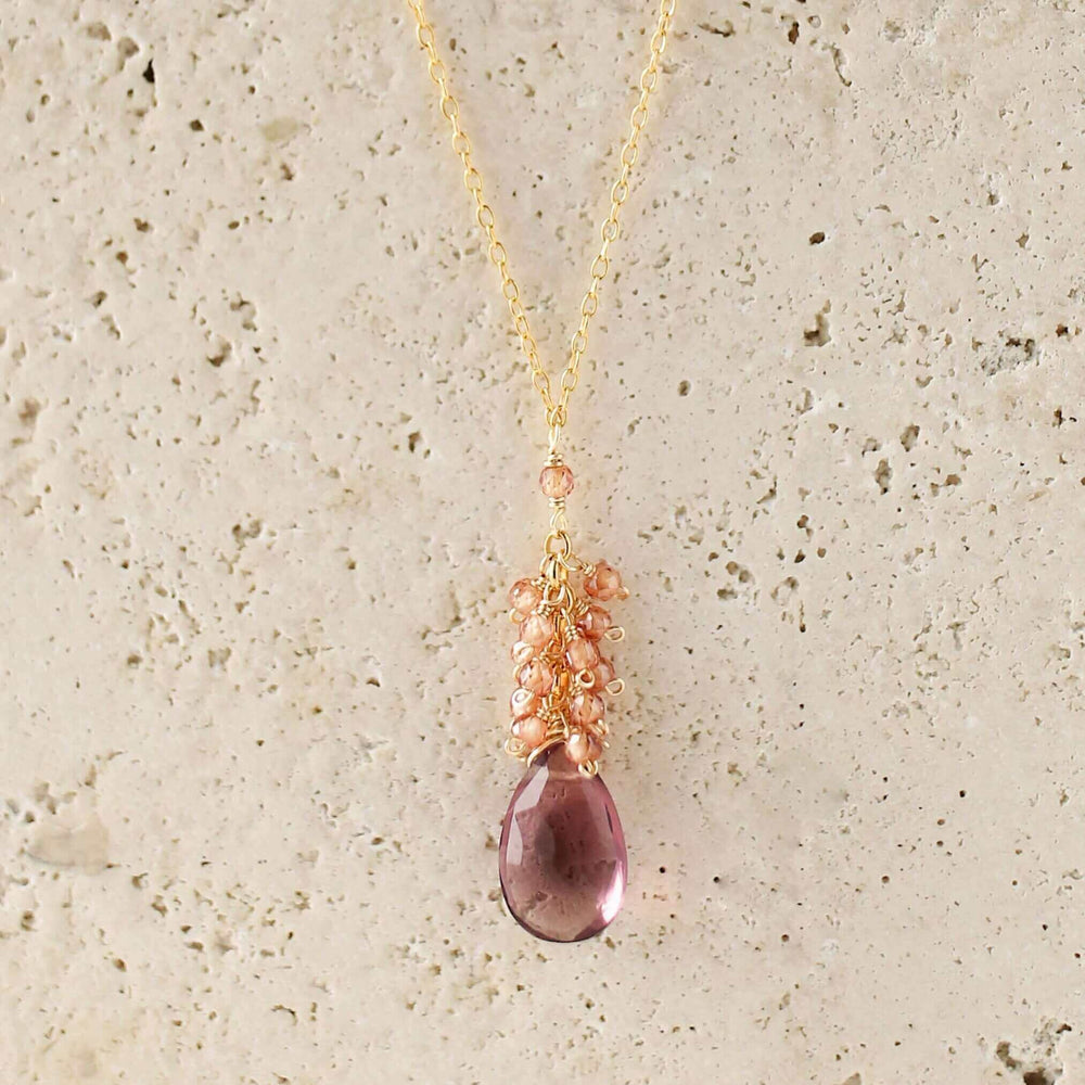 Vibrant rhodolite garnet gemstones paired with a cluster of mini champagne quartz gems Gold Necklace