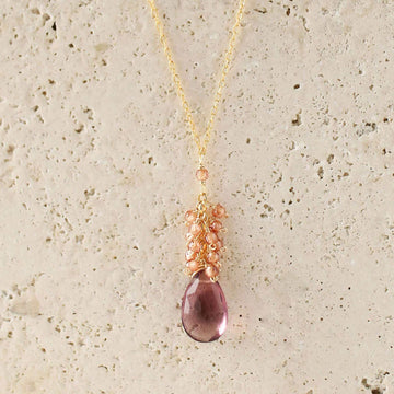 Vibrant rhodolite garnet gemstones paired with a cluster of mini champagne quartz gems Gold Necklace