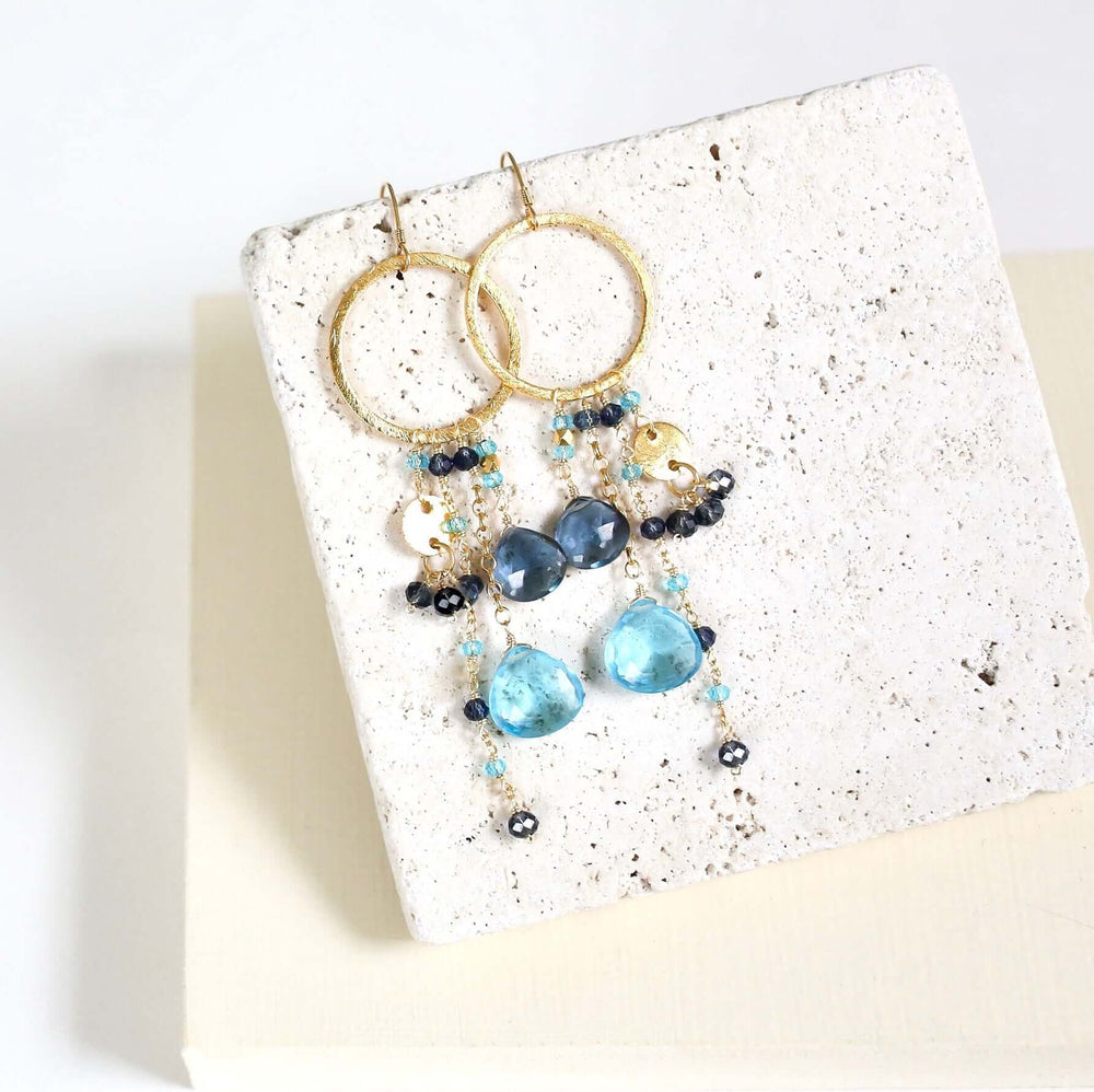 Multiple strands of lush gems sparkle on a hoop with Blue Gemstone Dangle Gold Earrings