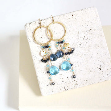 Multiple strands of lush gems sparkle on a hoop with Blue Gemstone Dangle Gold Earrings