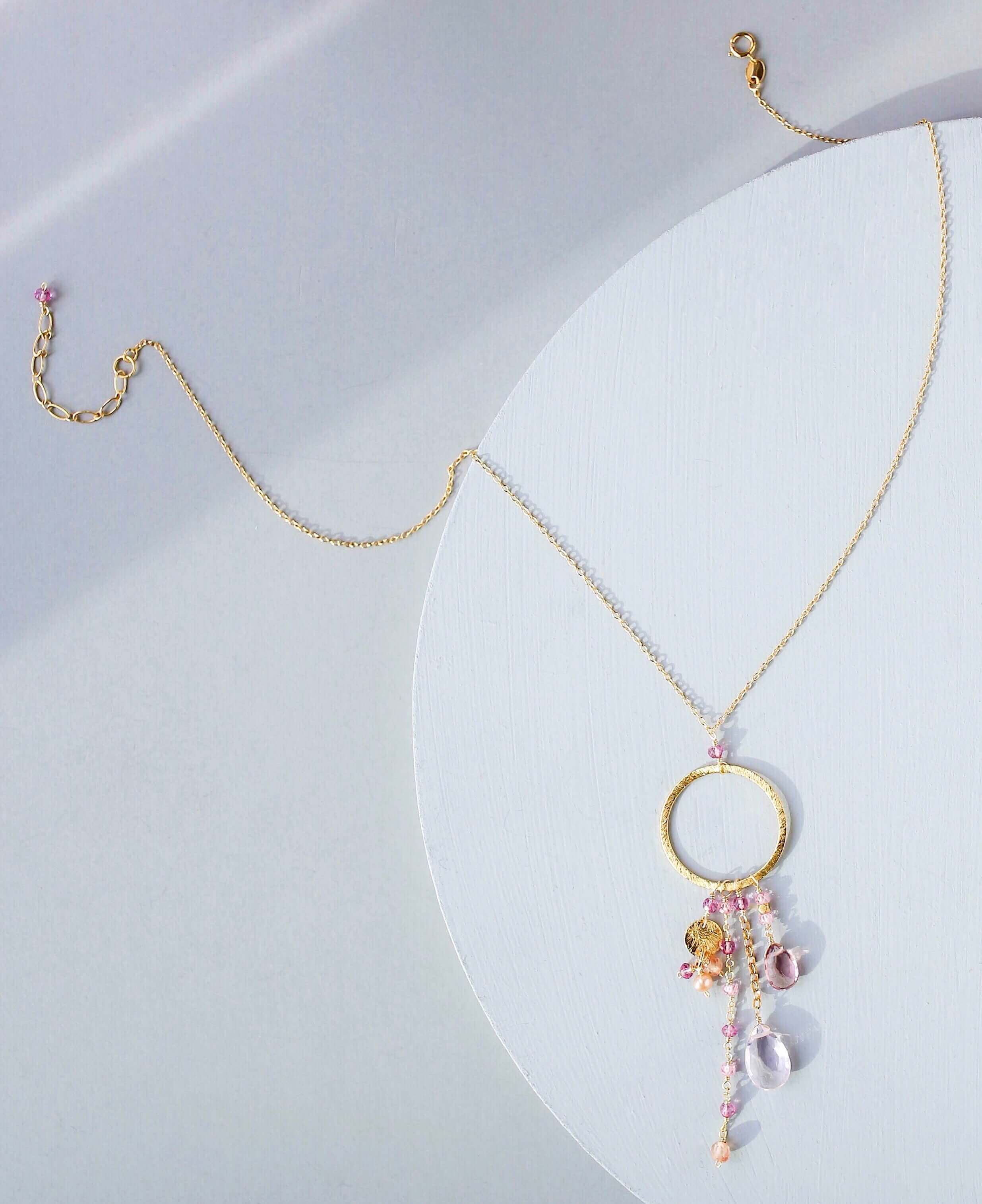 Multiple strands of lush gems sparkle on a hoop with rose quartz and pink tourmaline  gemstone Pendant Gold Necklace