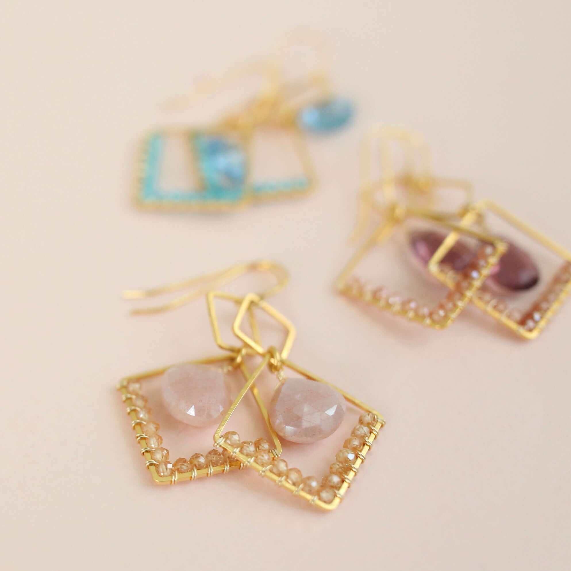 Gold geometric earrings with rhodolite garnet and champagne quartz gemstones