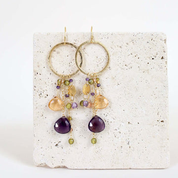 Multiple strands of lush gems sparkle on a hoop with Amethyst Gemstone Dangle Gold Earrings