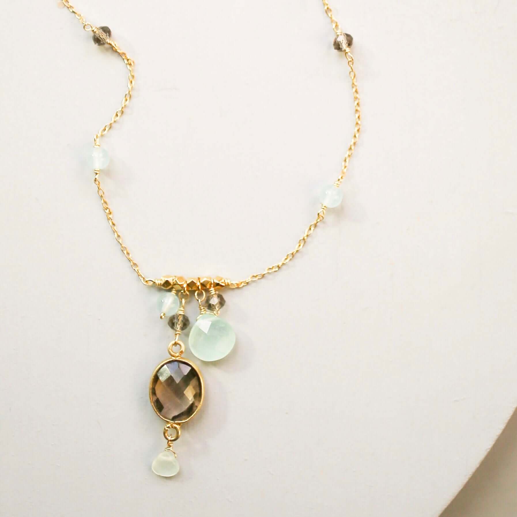 Beautiful bezel set smoky quartz gemstone surrounded by aqua chalcedony accent stones