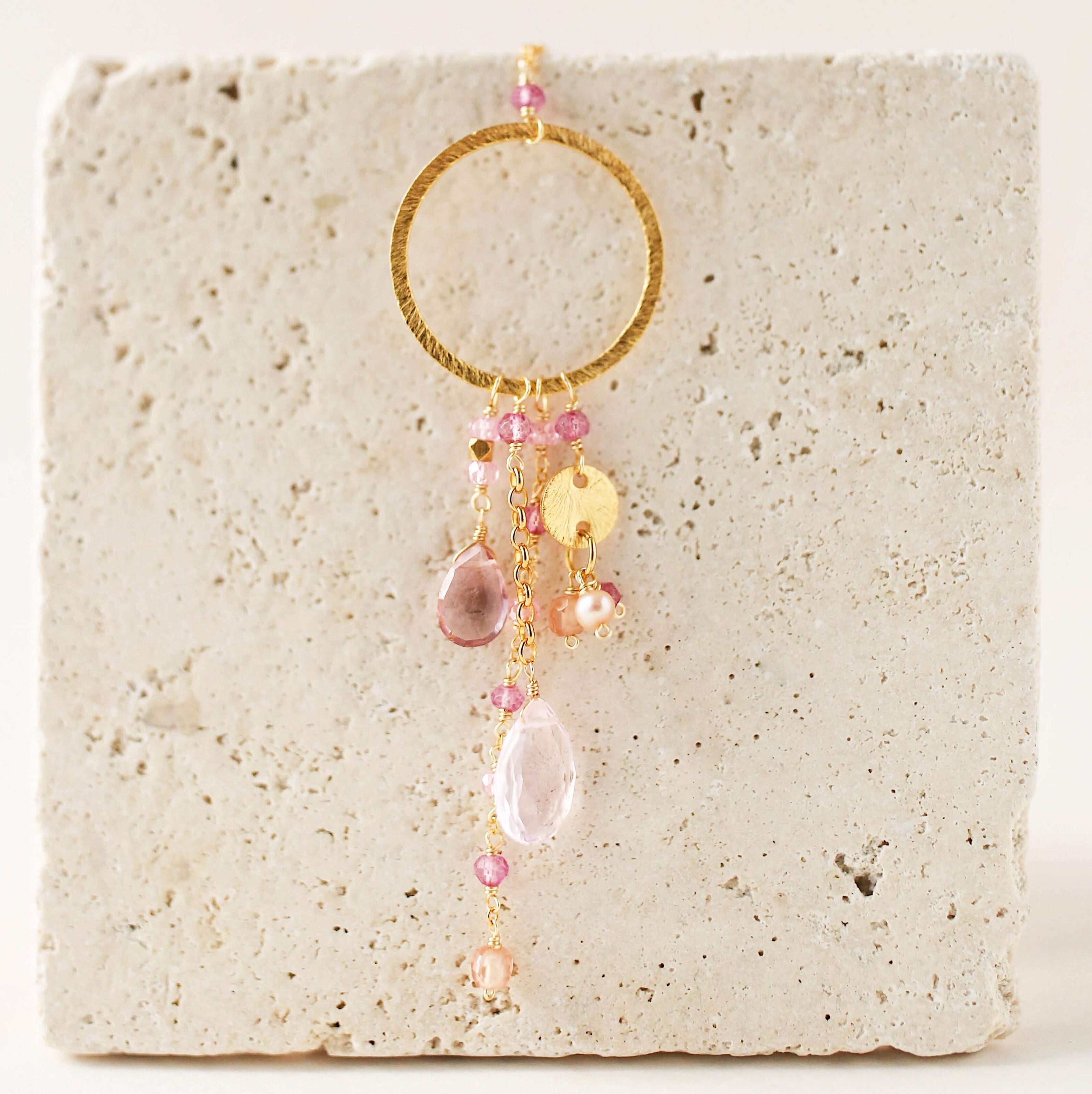 Multiple strands of lush gems sparkle on a hoop with rose quartz and pink tourmaline  gemstone Pendant Gold Necklace