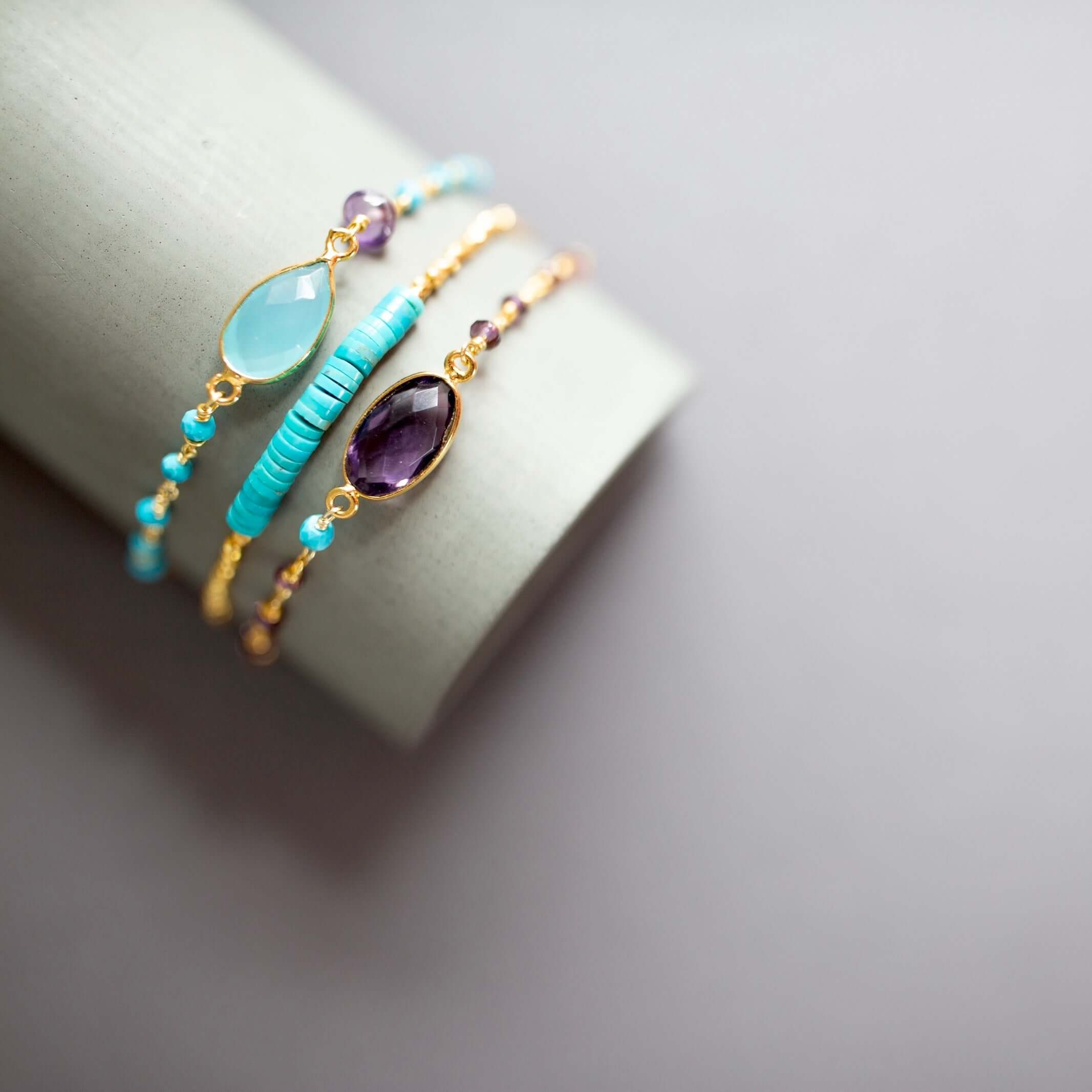 Gemstone arm candy duo: Aqua Blue Chalcedony and Amethyst bracelets. Adjustable, 14k gold plated, NYC-made.