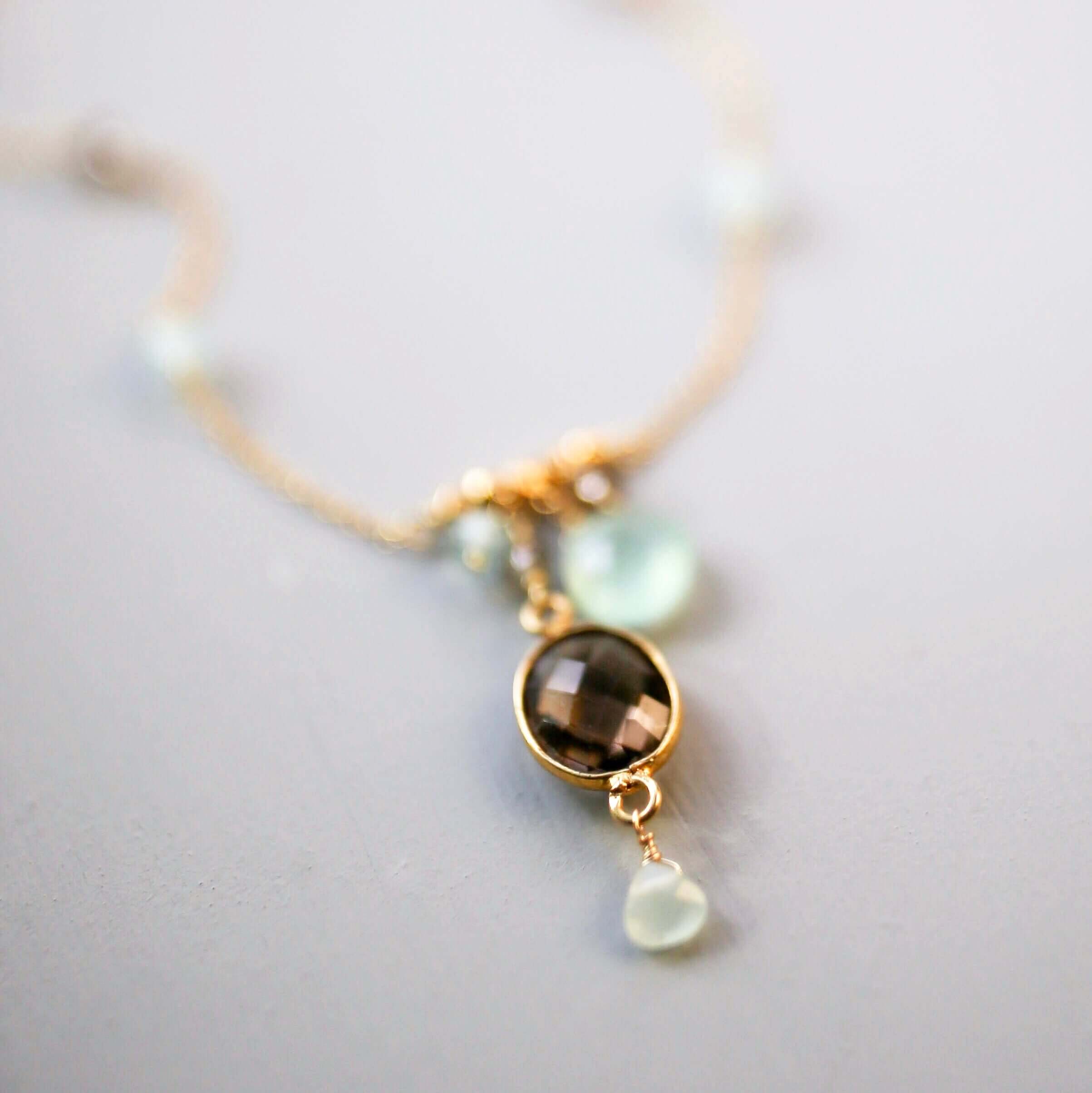 Beautiful bezel set smoky quartz gemstone surrounded by aqua chalcedony accent stones