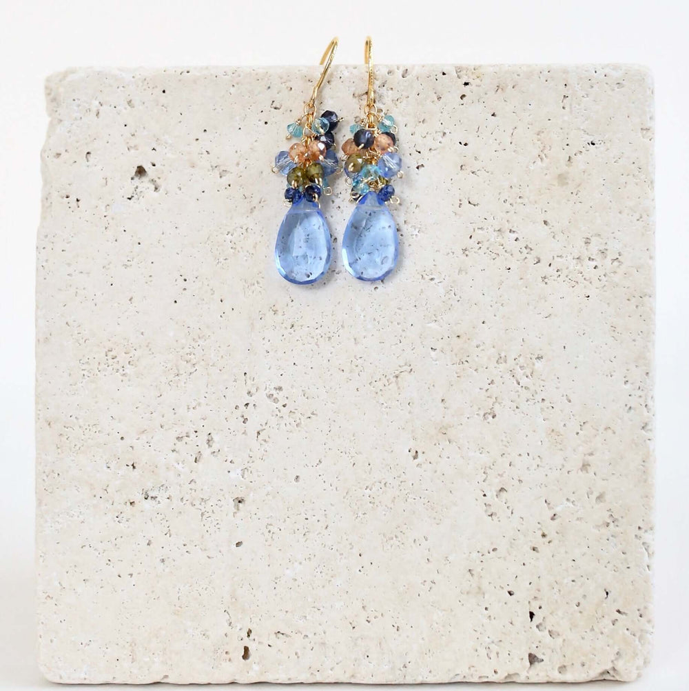 Gold drop earrings made with sky blue quartz topped with a blue cluster of gems