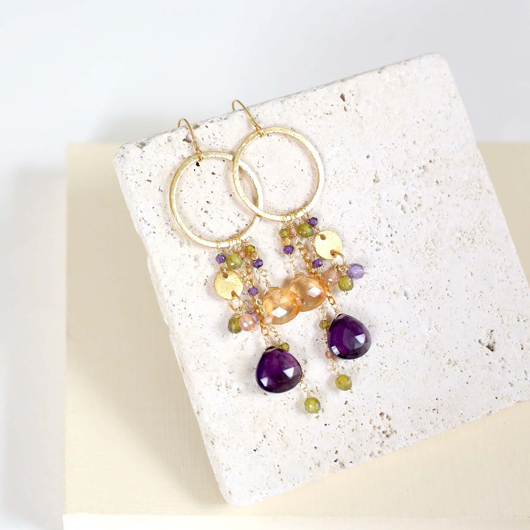 Multiple strands of lush gems sparkle on a hoop with Amethyst Gemstone Dangle Gold Earrings