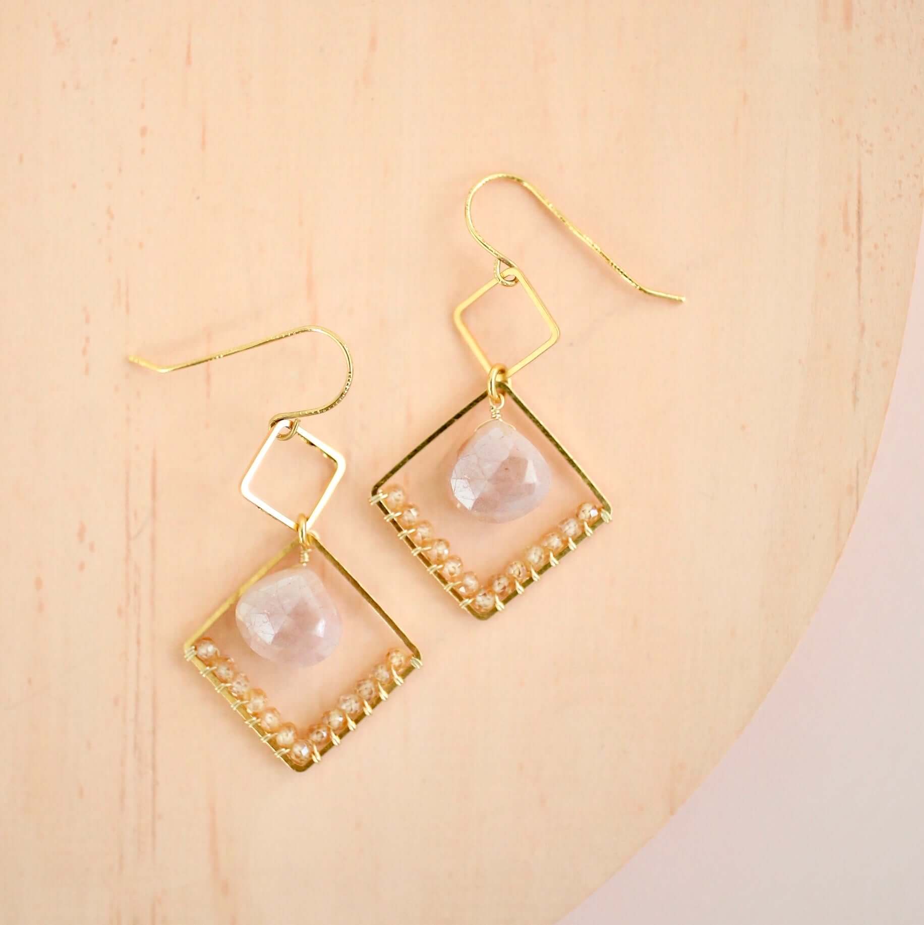 Gold triangle earrings with Peach Moonstone and Champagne Quartz gemstones, French hooks.