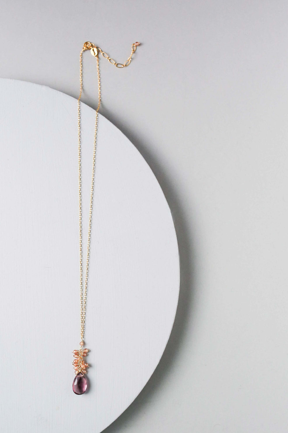 Vibrant rhodolite garnet gemstones paired with a cluster of mini champagne quartz gems Gold Necklace