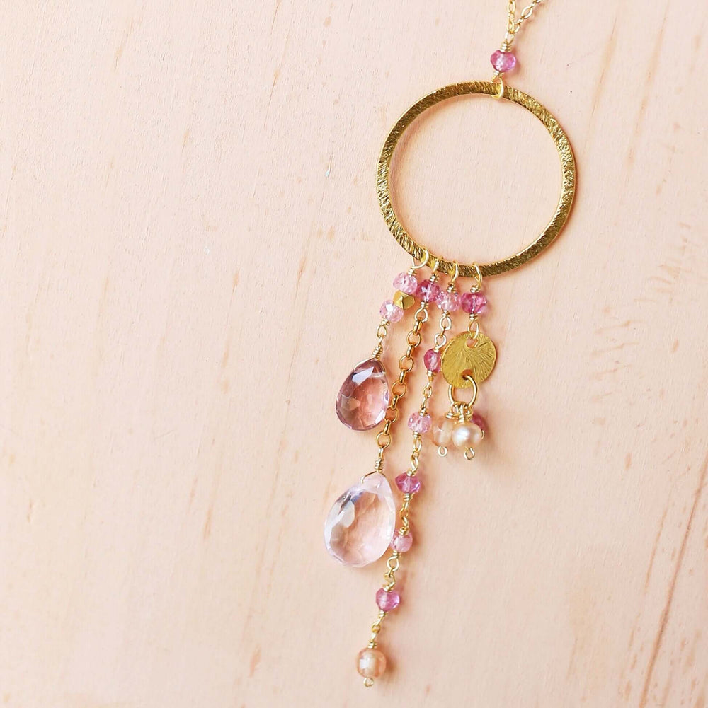 Multiple strands of lush gems sparkle on a hoop with rose quartz and pink tourmaline  gemstone Pendant Gold Necklace
