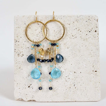 Multiple strands of lush gems sparkle on a hoop with Blue Gemstone Dangle Gold Earrings