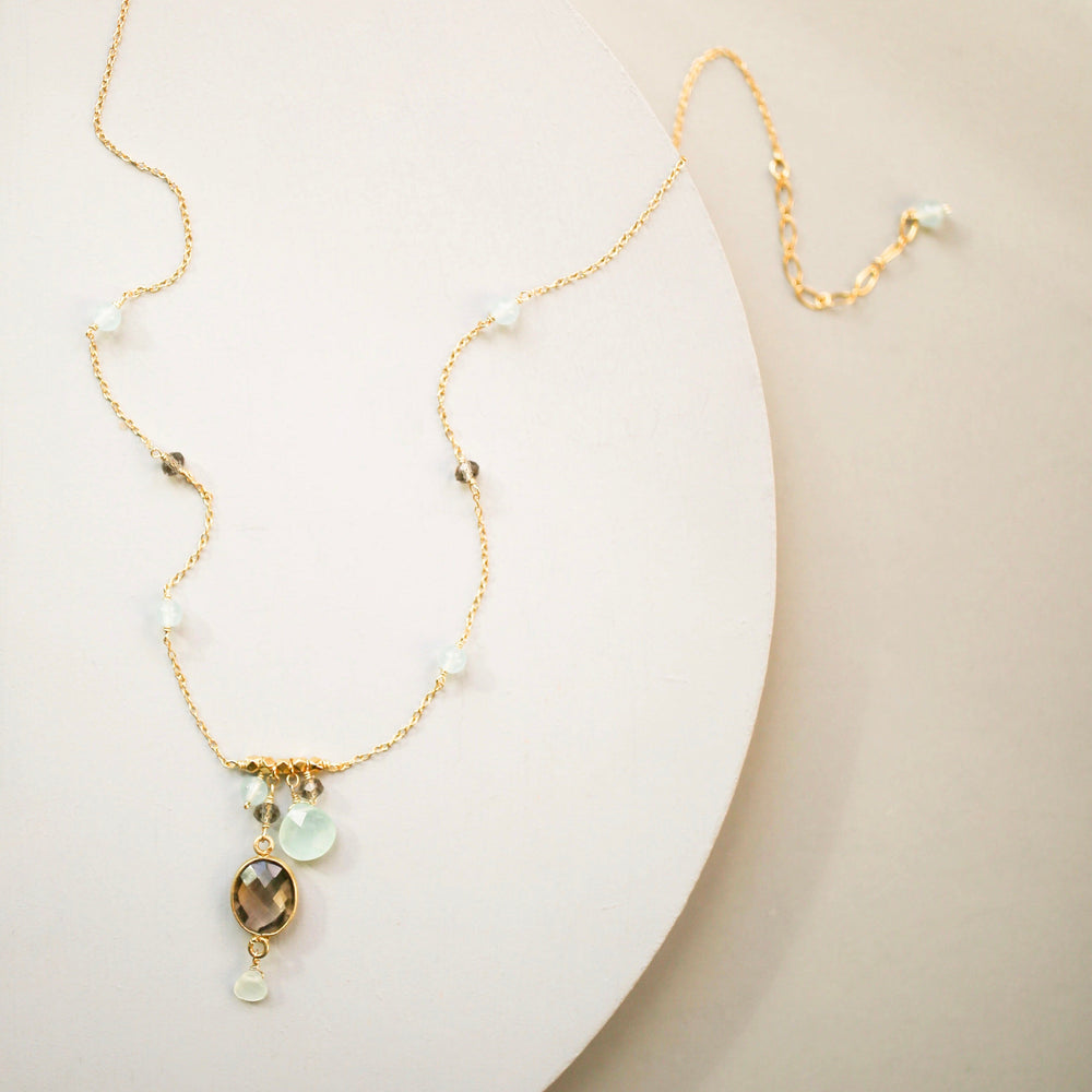 Beautiful bezel set smoky quartz gemstone surrounded by aqua chalcedony accent stones