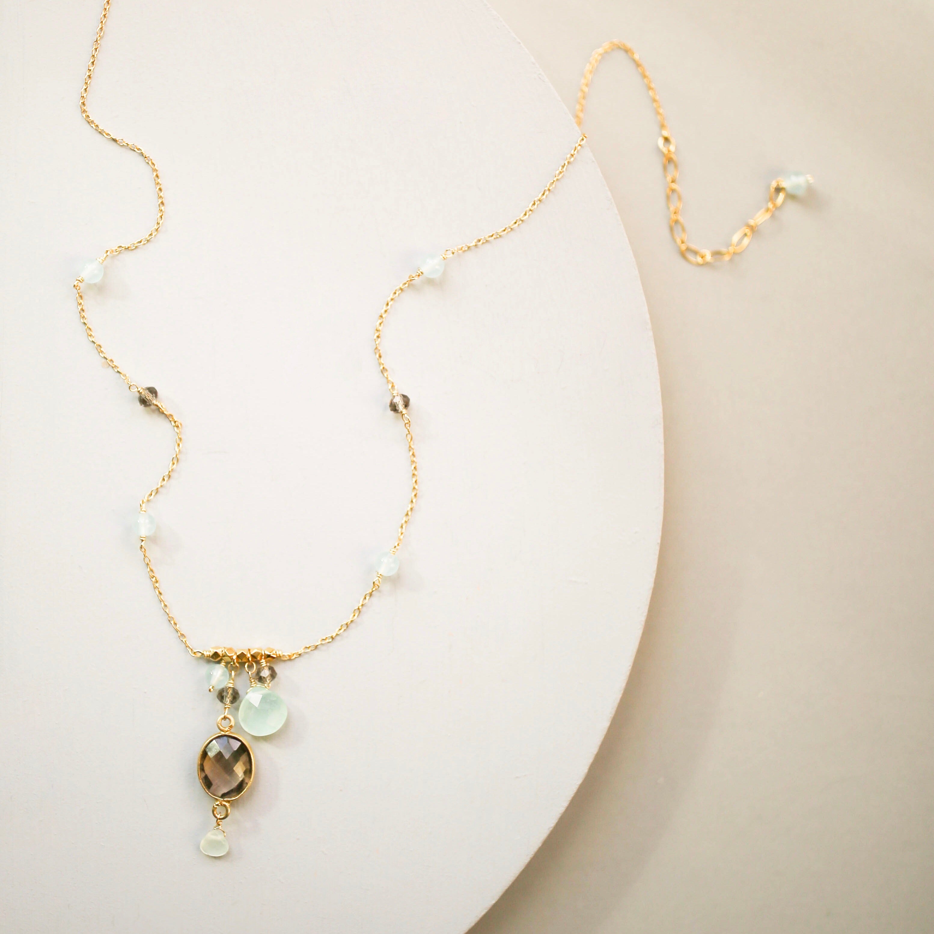 Beautiful bezel set smoky quartz gemstone surrounded by aqua chalcedony accent stones