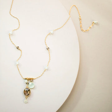 Beautiful bezel set smoky quartz gemstone surrounded by aqua chalcedony accent stones