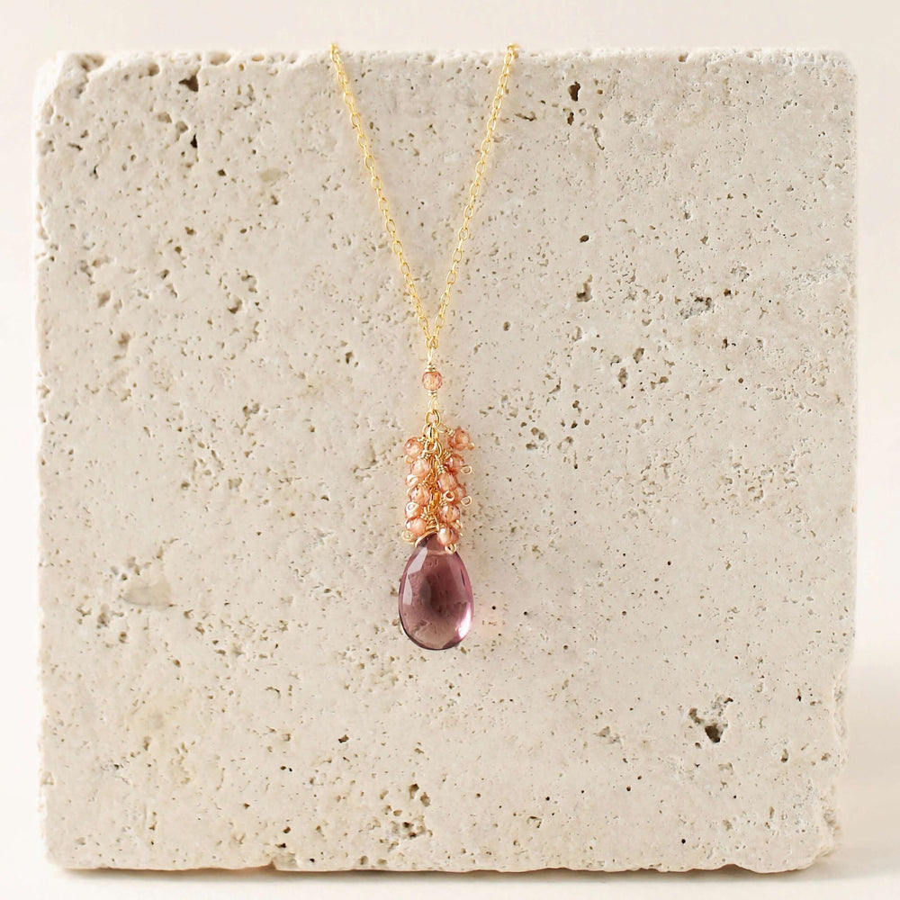 Vibrant rhodolite garnet gemstones paired with a cluster of mini champagne quartz gems Gold Necklace