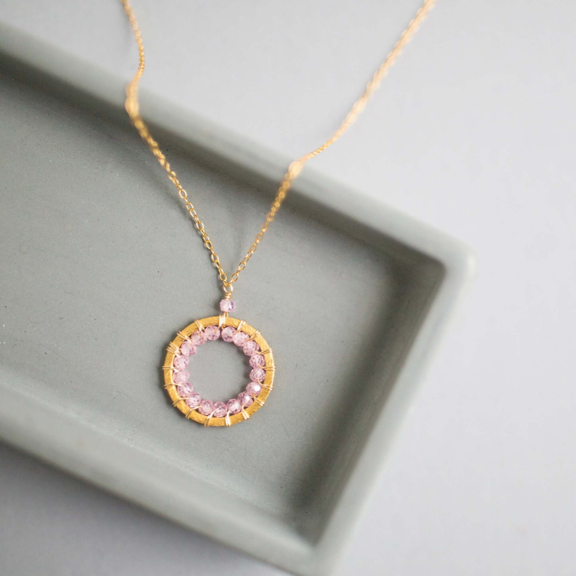 Mini Gold Circle Necklace with Unique Rose Quartz Gemstones Detail.