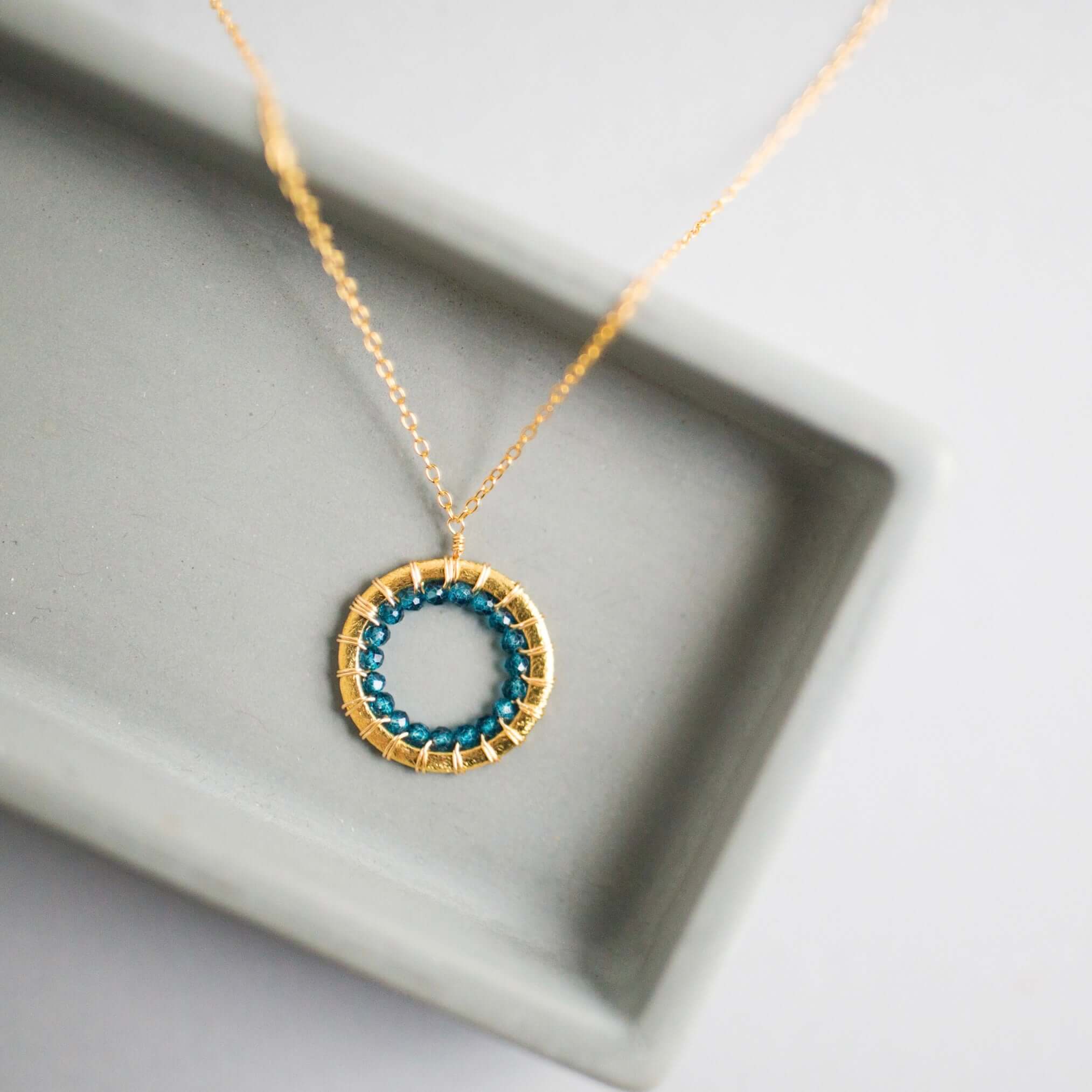 Mini Gold Circle Necklace with Unique London Blue  Quartz Gemstones Detail.